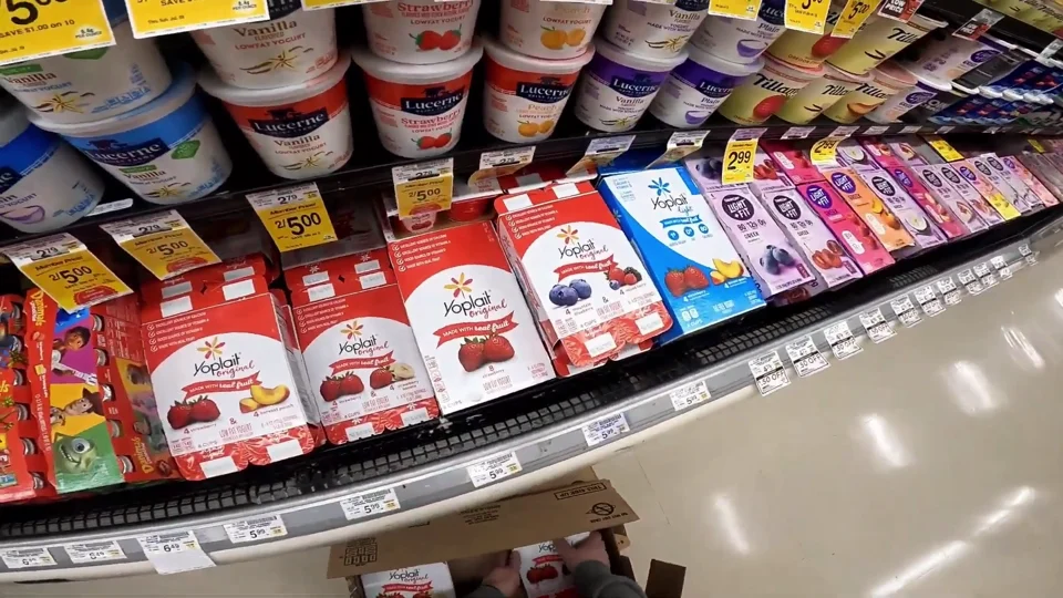 First-person video still of a grocery store aisle shelf with packaged products